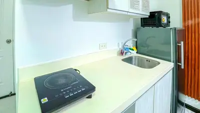 a kitchen with a sink and a scale on the counter at Stunning 1-Bed Apartment in Paranaque in Manila