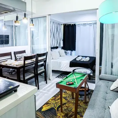 a room with a living room and a room with a table at Stunning 1-Bed Apartment in Paranaque in Manila