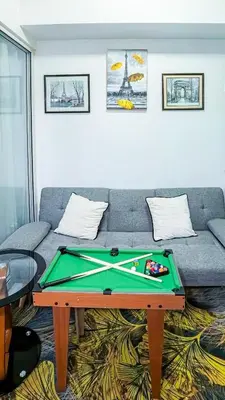 a living room with a couch and a pool table at Stunning 1-Bed Apartment in Paranaque in Manila
