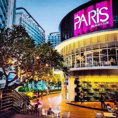 a large building with a pink sign on it at Stunning 1-Bed Apartment in Paranaque in Manila