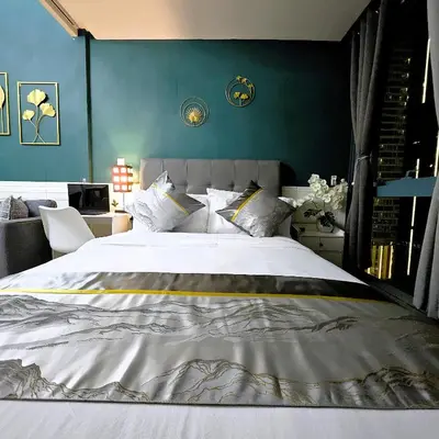 a bedroom with a large white bed with blue walls at Lovely Condo in Uptown, BGC - Soleil Pacific Suite in Manila