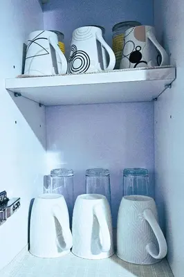 a shelf with glasses and cups on it at Lovely Condo in Uptown, BGC - Soleil Pacific Suite in Manila