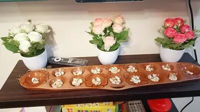 a tray of cupcakes on a table with flowers at Condo in Parañaque in Manila