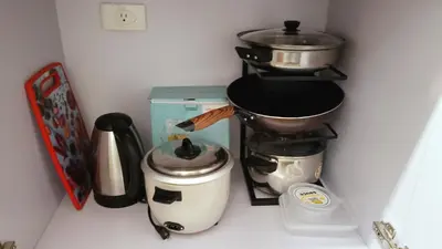 a kitchen counter with a coffee maker and a coffee pot at Condo in Parañaque in Manila