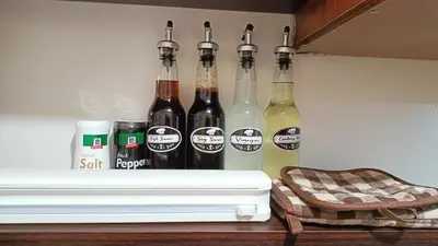 four bottles of wine on a shelf in a refrigerator at Condo in Parañaque in Manila