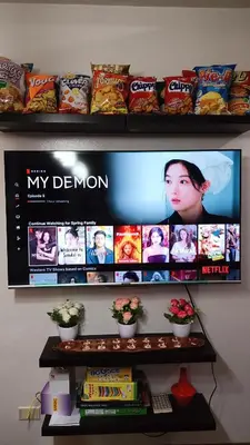 a shelf with a tv and some food on it at Condo in Parañaque in Manila