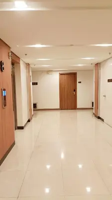 an empty hallway of a building with a wooden door at Condo in Parañaque in Manila