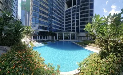 a large swimming pool in front of a tall building at 2BR at the FORT BGC near Malls, Restaurants & Shops in Manila