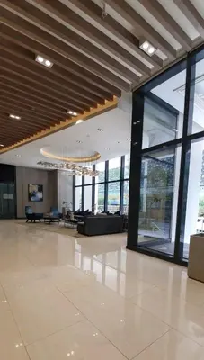 an empty lobby with a large open room with windows at 2BR at the FORT BGC near Malls, Restaurants & Shops in Manila