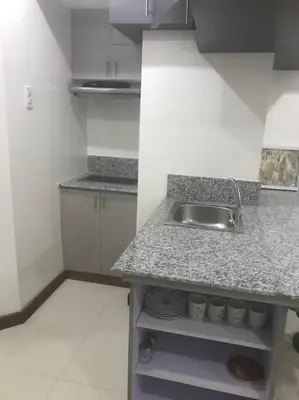 a kitchen with a sink and a counter top at Loft Style Condo Unit in Makati with Netflix WIFI in Manila