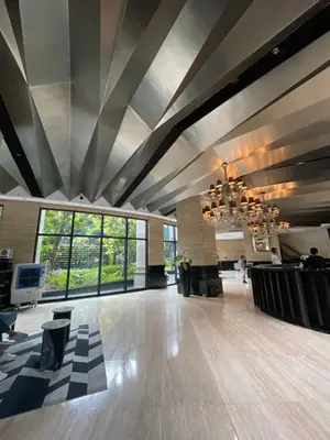 a large lobby with a ceiling with a chandelier at Quiet Condo with Fast WiFi, Own Balcony, Pool and Gym in Manila