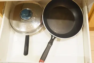 a frying pan and a pot in a drawer at Quiet Condo with Fast WiFi, Own Balcony, Pool and Gym in Manila