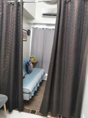 a room with curtains and a bench in a room at Moa SHORE 3 TOWER 2 RESIDENCE in Manila