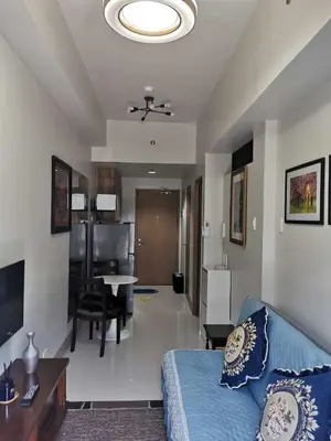 a living room with a couch and a dining room at Moa SHORE 3 TOWER 2 RESIDENCE in Manila