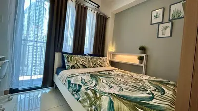 a bedroom with a bed and a large window at Homey 1BR Skyline at Lush Residences, Makati City in Manila