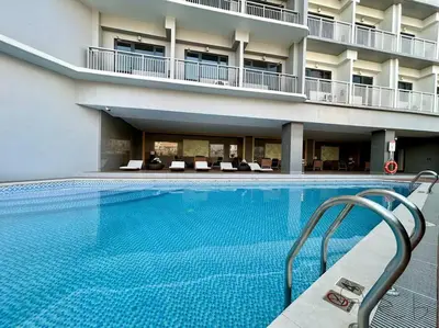 a large swimming pool in front of a building at Homey 1BR Skyline at Lush Residences, Makati City in Manila