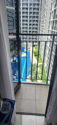 a view of a pool from a window in a building at Perfect blend of home & comfort in Manila