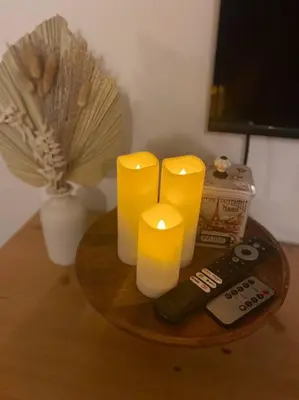 a table with two yellow candles and a remote control at Coastal Inspired 2BR Condo I Fast Wi-Fi I Near BGC in Manila