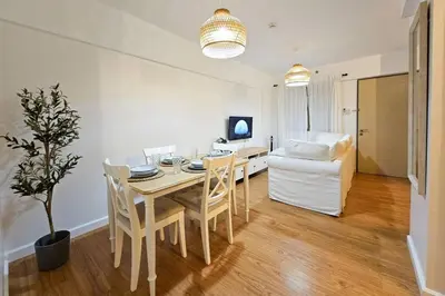 a dining room with a table and a couch at Coastal Inspired 2BR Condo I Fast Wi-Fi I Near BGC in Manila