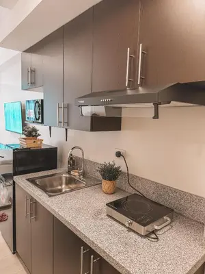 a kitchen with a sink and a counter top at Mayas Home in Pasig Aesthetic and Cozy with Pool access and Netflix in Manila