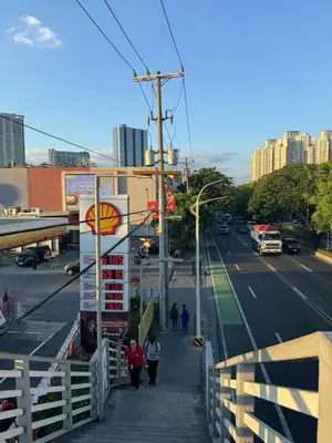 a city street with people walking down a sidewalk at Mayas Home in Pasig Aesthetic and Cozy with Pool access and Netflix in Manila