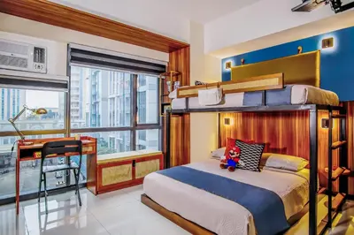 a bedroom with a bunk bed and a balcony at 1Up Retreat at BGC, Cinema Style near Mall in Manila