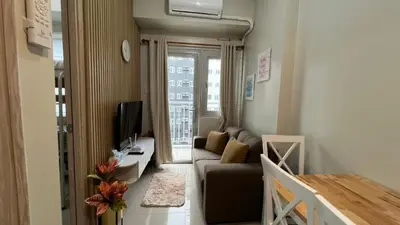 a small living room with a couch and a tv at UrbanEase Living at Charm Residences Near Sta Lucia Mall and Robinsons Mall in Manila
