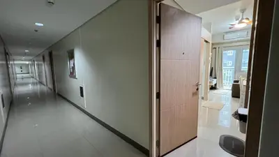 a hallway with a door in a building at UrbanEase Living at Charm Residences Near Sta Lucia Mall and Robinsons Mall in Manila