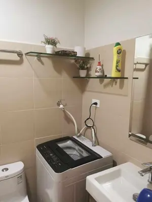 a small bathroom with a toilet and a sink at Mall of Asia Pasay Shore 3 tower condotel in Manila