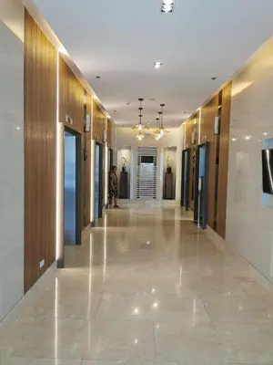 a hallway in a building with wooden walls and a lobby at Mall of Asia Pasay Shore 3 tower condotel in Manila