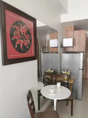 a kitchen and dining room with a table and a refrigerator at Mall of Asia Pasay Shore 3 tower condotel in Manila