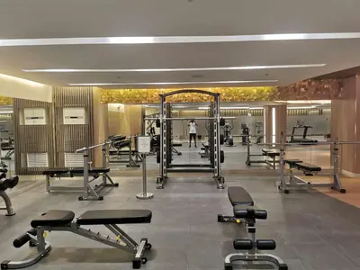 a gym with several treadmills and weights at Mall of Asia Pasay Shore 3 tower condotel in Manila