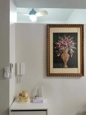 a picture of a vase of flowers on a wall at Mall of Asia Pasay Shore 3 tower condotel in Manila