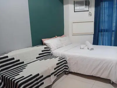 two beds sitting next to each other in a room at Manila Condotel near US Embassy in Manila