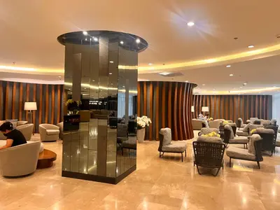 a lobby with a waiting room with couches and chairs at Shore 2 Residences in Manila