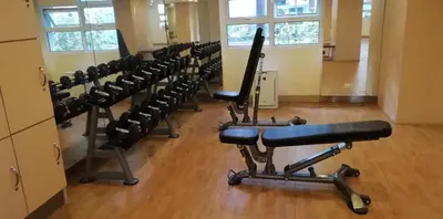 a row of exercise equipment in a gym at 101 Newport Boulevard in Manila