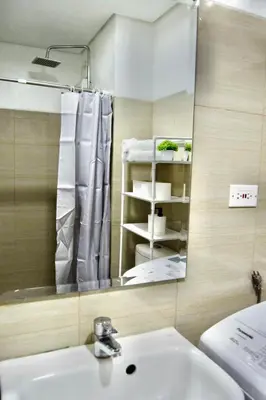 a bathroom with a sink and a mirror at 1 BR Condo with Balcony in Manila