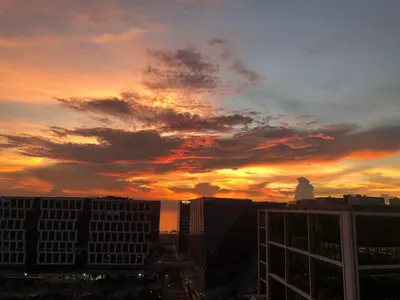 a sunset view of a city skyline with buildings at 1 BR Condo with Balcony in Manila