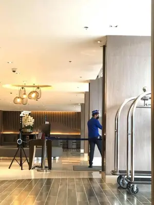 a man standing in the doorway of a hotel lobby at 1 BR Condo with Balcony in Manila