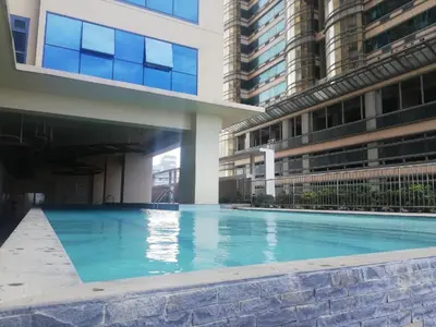 a swimming pool in the middle of a building at Grand Riviera suite Condotel Near SLEC in Manila