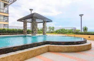 a swimming pool with a gazebo at Grand Riviera suite Condotel Near SLEC in Manila