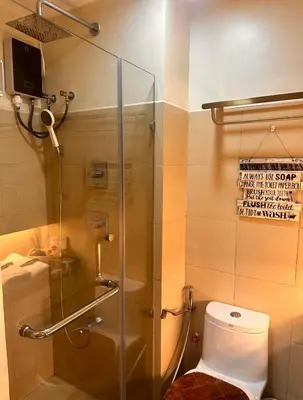 a bathroom with a glass shower with a toilet at Kendra Suite at Shore 3 Residences, MOA in Manila