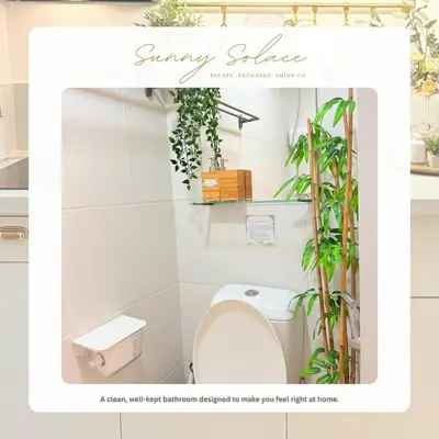 a bathroom with a toilet and plants on the wall at Sunny Solace a Homey Condo in Filinvest Alabang in Manila