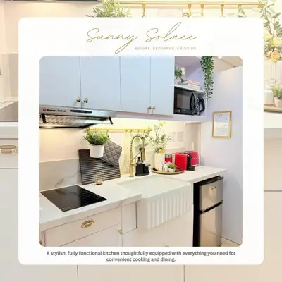 a kitchen with white cabinets and a sink at Sunny Solace a Homey Condo in Filinvest Alabang in Manila