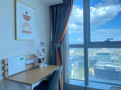 a room with a desk and a large window at BGC Skyline 2BR Suite with Parking in Uptown BGC in Manila