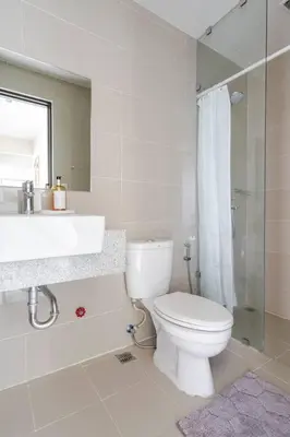 a bathroom with a toilet and a sink and a shower at BGC Skyline 2BR Suite with Parking in Uptown BGC in Manila