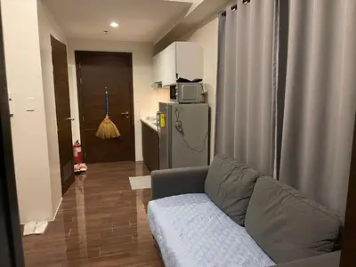 a living room with a couch and a refrigerator at Destina at Air Residences, Makati, Metro Manila in Manila