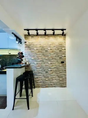 a kitchen with two stools in front of a brick wall at La Prima - The Perfect Urban Oasis in Santa Rosa