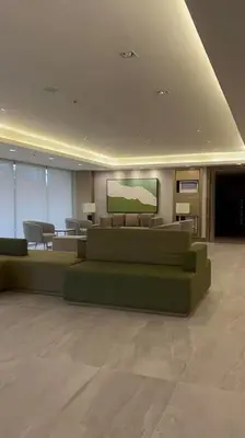 a living room with couches and chairs in a building at 1014 - Cavite Minimalist Condo with Resort-like Amenities & Hi Speed Wifi in Dasmariñas