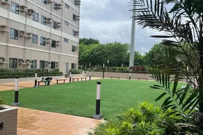 a park with benches in front of a building at 1014 - Cavite Minimalist Condo with Resort-like Amenities & Hi Speed Wifi in Dasmariñas